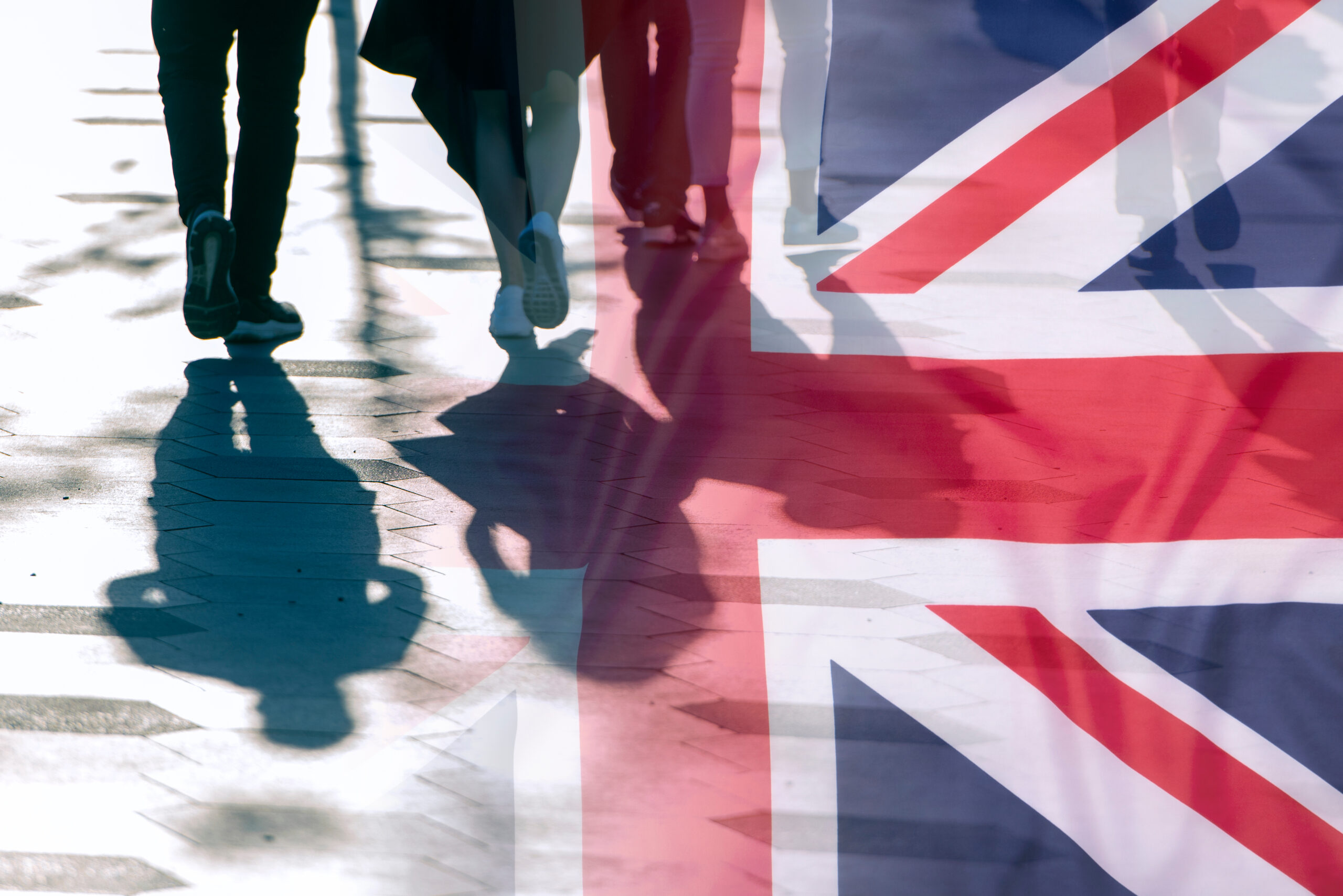 Image of the Union Jack and people walking, to show immigration and the Good Character Guidance Amendment to Block Refugees from Naturalisation.