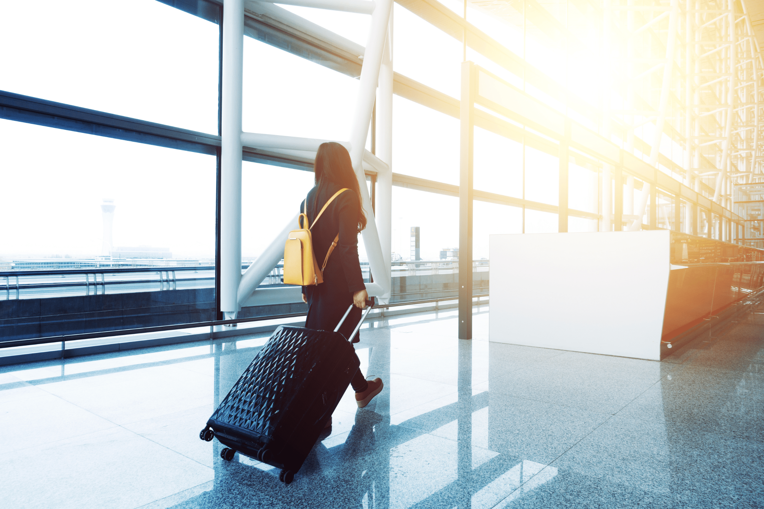 Image of a woman at an airport leaving the country. Showing an absence from the UK.